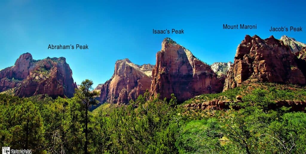 Court of the Patriarchs with labeled peaks: Abraham's Peak, Isaac's Peak, Mount Maroni, and Jacob's Peak, below a clear blue sky.