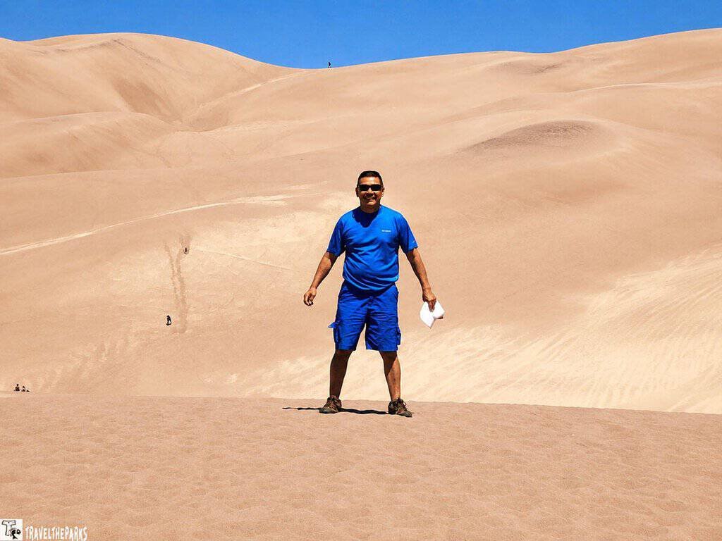 Person standing on sand dunes at Great Sand Dunes National Park.