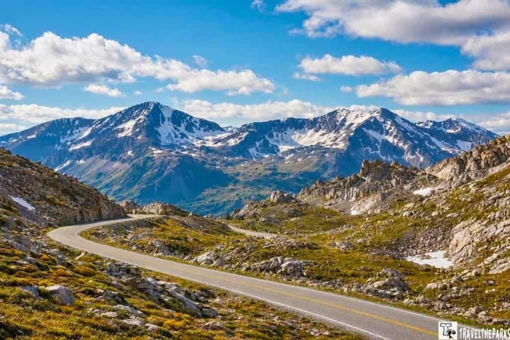 A breathtaking panorama of Trail Ridge Road in RMNP, showcasing the path to the summit of majestic mountains.