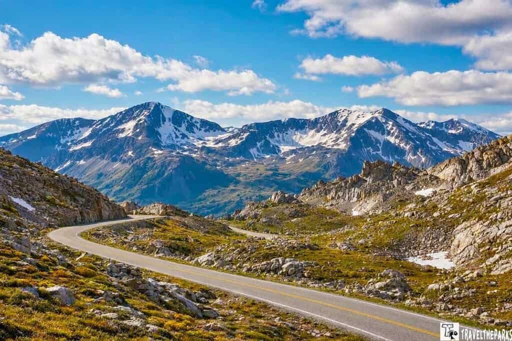 A breathtaking panorama of Trail Ridge Road in RMNP, showcasing the path to the summit of majestic mountains.