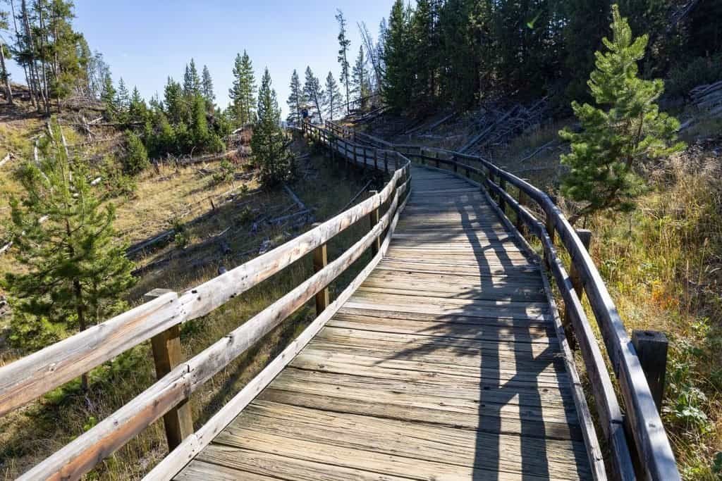 Scenic wooden walkway guiding visitors to the mud volcano in Yellowstone's stunning Hayden Valley.