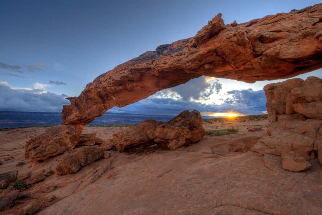 A natural sandstone arch at sunset in Grand Staircase-Escalante National Monument.