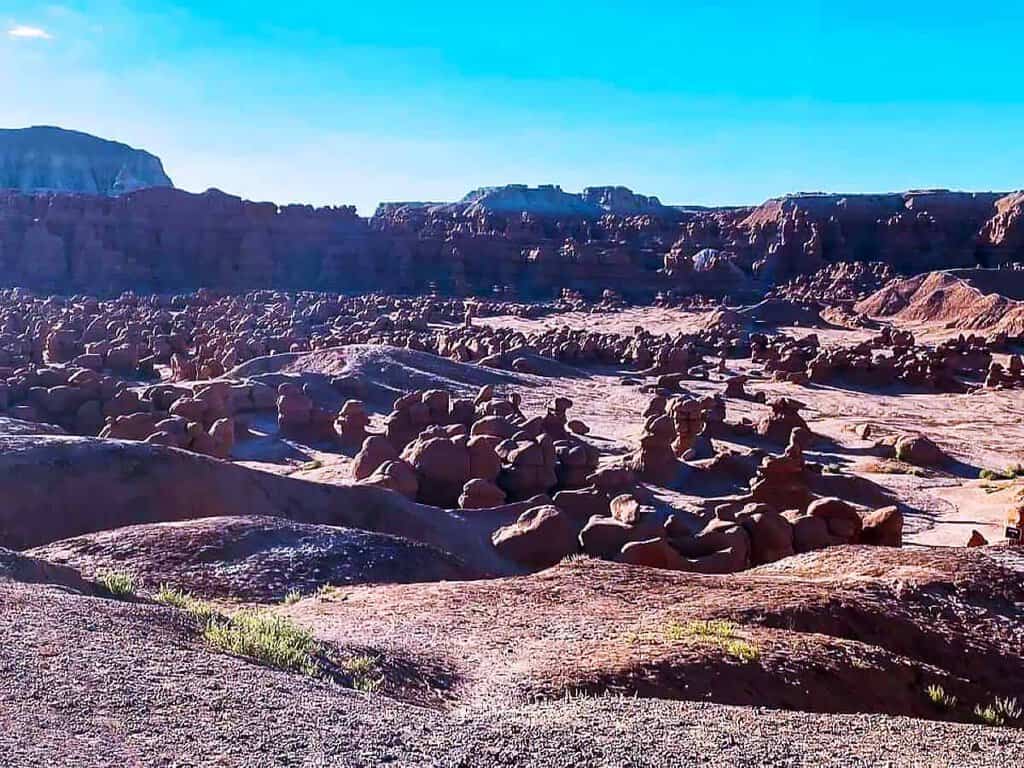 HOODOOS TURNED GOBLINS: Desert landscape with numerous rounded rock formations under a clear blue sky.