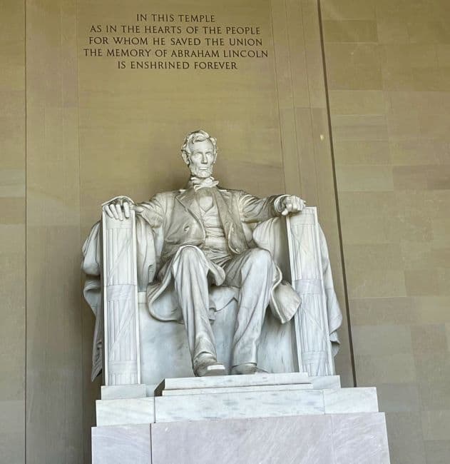 Statue of Abraham Lincoln seated in a chair at the Lincoln Memorial.