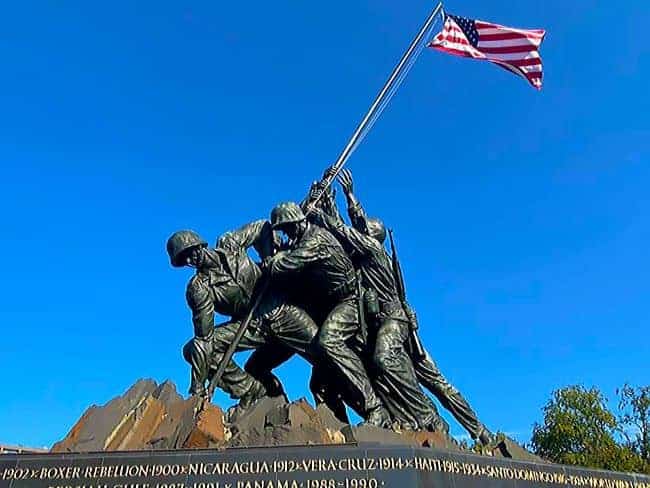 U.S. Marine Corps War Memorial–Iwo Jima Memorial-Bronze sculpture of six soldiers raising an American flag on a pedestal with historical event engravings.