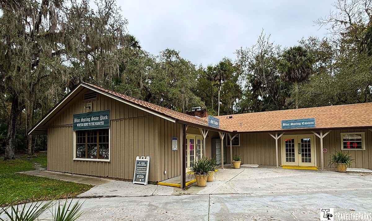 Building at Blue Springs State Park with signs for a gift shop and canteen, surrounded by trees.