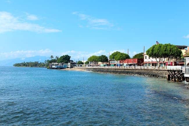 a scenic coastal view of Lahaina Maui with a vibrant blue ocean in the foreground. 