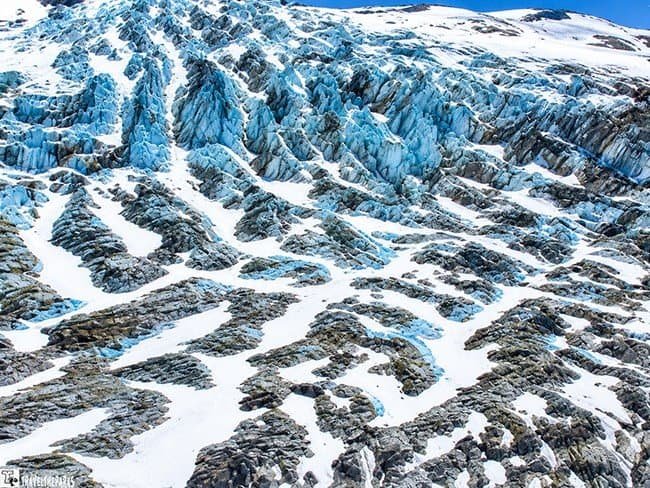 Double Glacier Ice Field: A glacier with intricate patterns of blue and white ice, showcasing deep crevices and smooth surfaces, conveys a serene and majestic natural landscape.