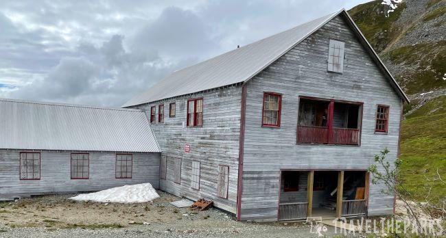 Cookhouse & Mess Hall Historic wooden building at Independence Mine in Hatcher Pass with gray siding and red trim.