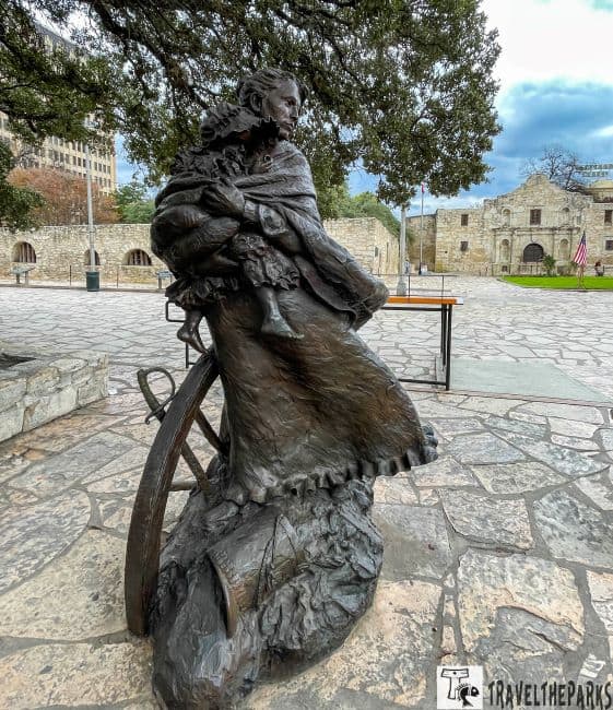 Bronze of Susanna Dickinson survivor cradling her daughter.