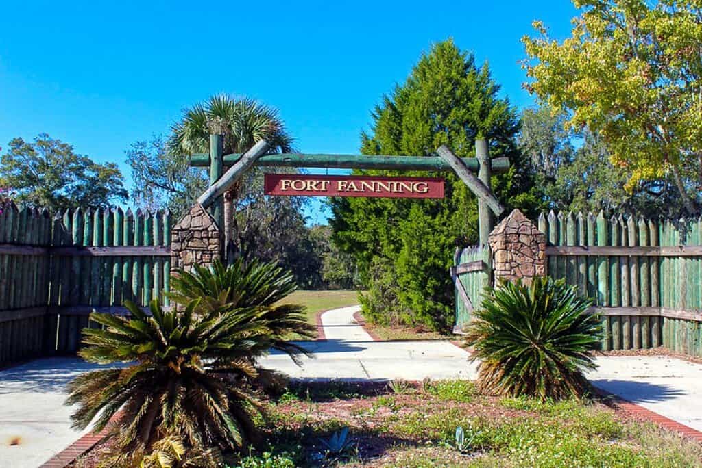 Entrance to Fort Fanning with a wooden archway and greenery.