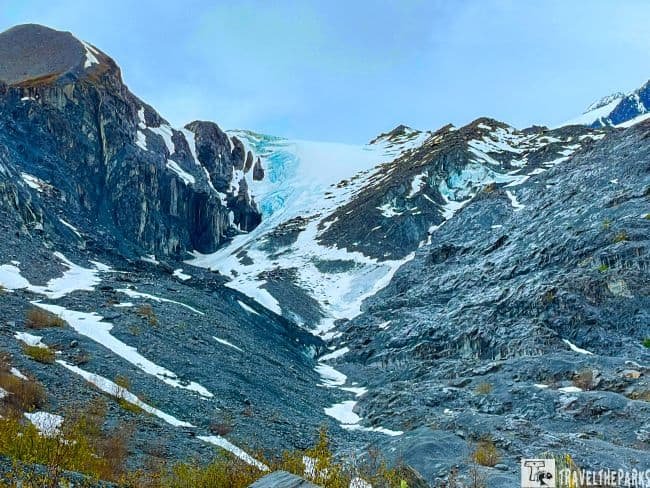 Worthington Glacier: Mountain landscape with a glacier, rocky terrain, and patches of snow under an overcast sky.