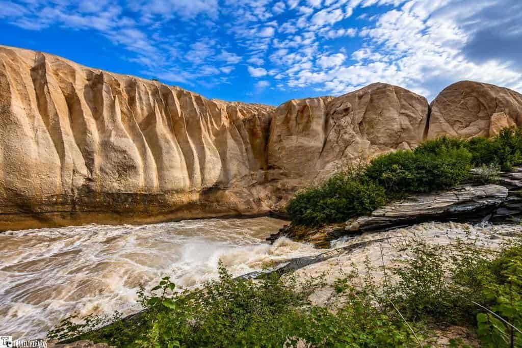 wall of ash at Ukak Falls Valley of Ten Thousand Smokes. A turbulent river flows 