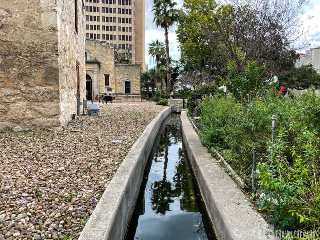 old acequia irrigation ditch running behind the Alamo church