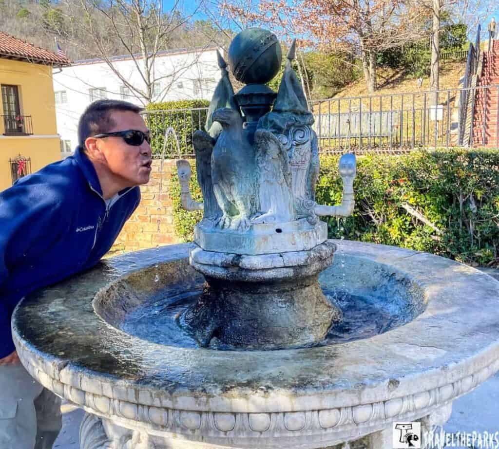 man drinking from the magical fountain hot Springs National Park