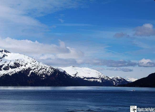 Snow-capped mountains in Prince William Sound under a bright blue sky.