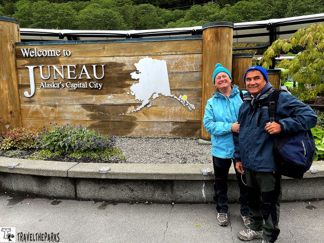 Two people in outdoor clothing stand by a