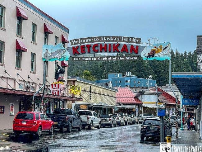 On an inside passage cruise main street view in Ketchikan, Alaska, featuring a welcome sign and colorful buildings.