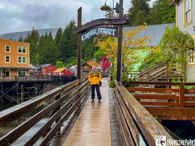 Creek Street sign and boardwalk with women standing under the sign