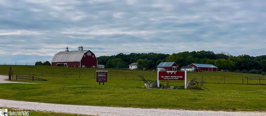 The farm at Prophetstown in a rural area with red barns and a sign reading "The Farm at Prophetstown."