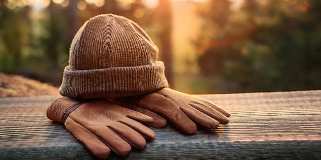 Hat and gloves on a park fence