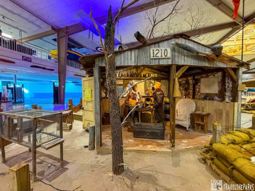 Pensacola Naval Aviation Museum exhibit featuring a wooden shack with historical artifacts and period-costumed mannequins representing WWI communications personnel.