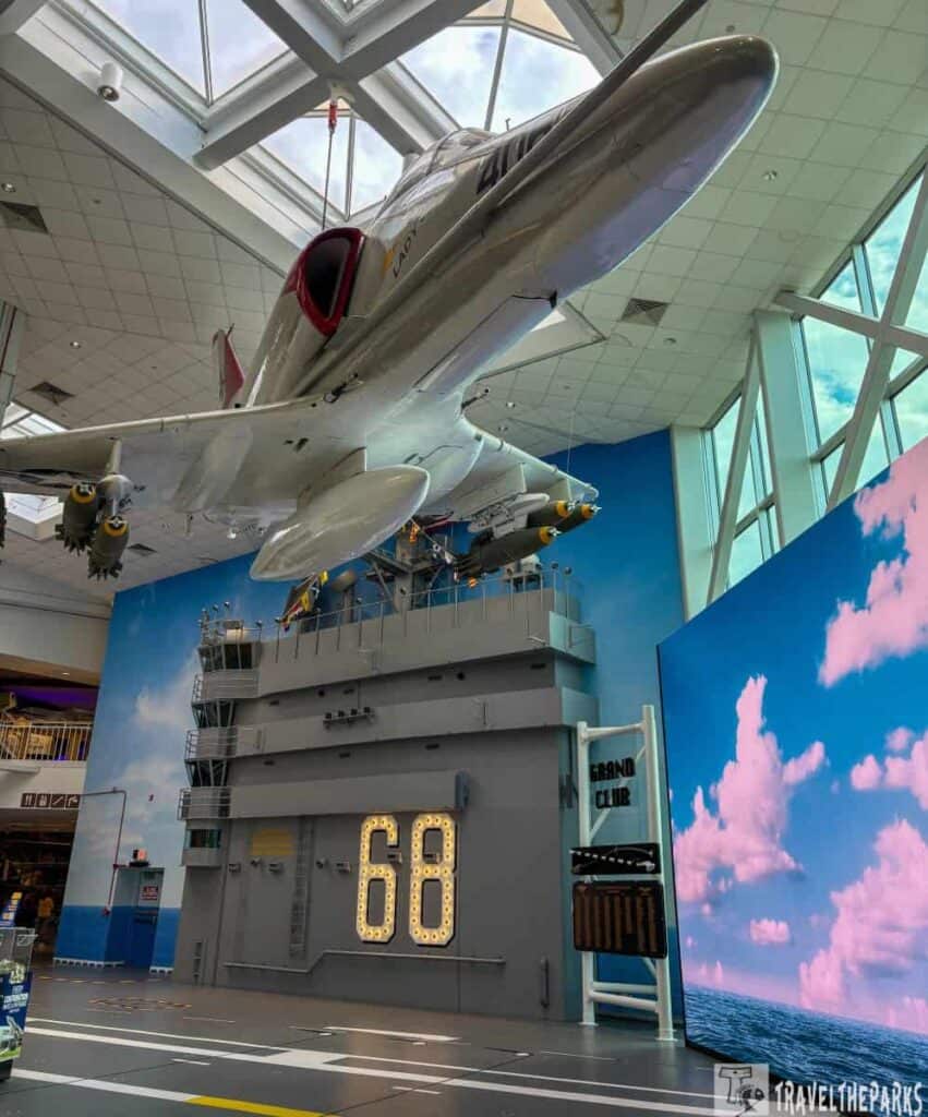 Exhibit of a fighter jet and USS Nimitz flight deck replica at the National Naval Aviation Museum.