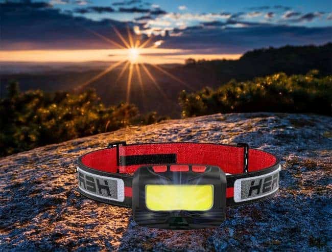 Headlamp on a rock with a sunset in the background.