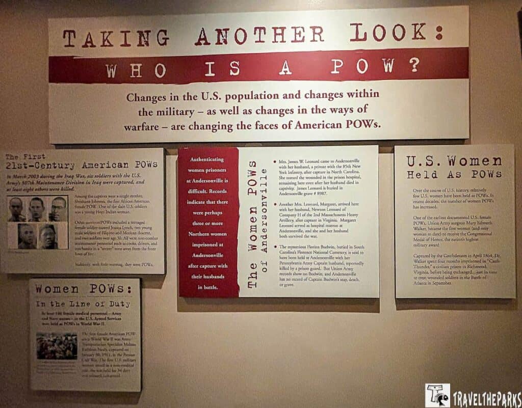 an exhibit panel with multiple sections discussing the evolving nature of American POWs, particularly women. At the top, a large headline reads "TAKING ANOTHER LOOK: WHO IS A POW?" with an explanatory subtext about changes in U.S. populations and military warfare impacting POW dynamics.