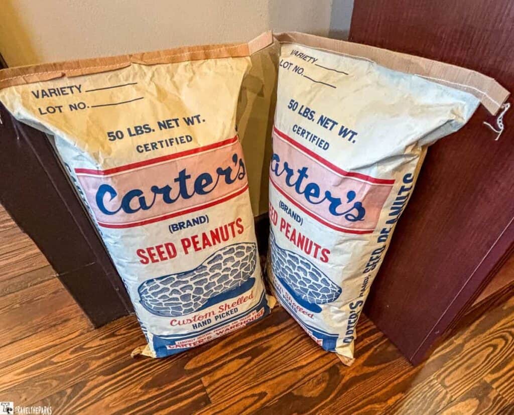Two sacks of Carter's Brand Seed Peanuts with labels and peanut illustration.