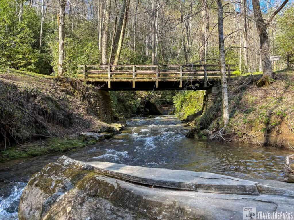 Wooden bridge over a creek in a forested area of the Smoky Mountains.