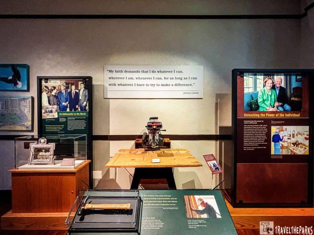 Museum exhibit featuring a quote by Jimmy Carter, a typewriter, and informational panels.