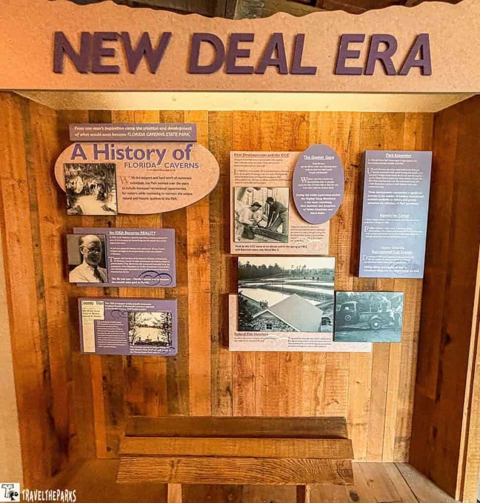 Informative display on the New Deal Era at Florida Caverns State Park, featuring text and historic photos on a wooden background.