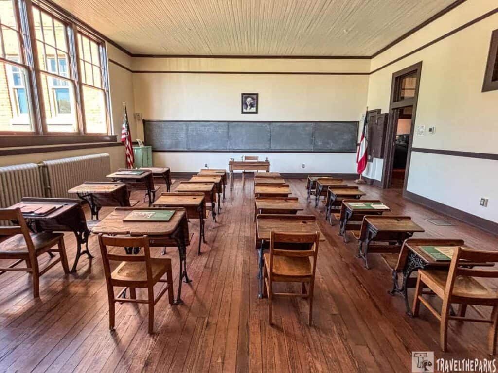 Plains High School vintage classroom with wooden desks, a blackboard, and large windows at the Jimmy Carter National Historic Park