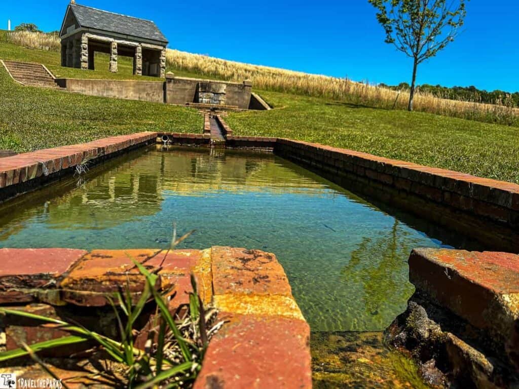 A view of the springhouse and the stairs leading down to the spring at Andersonville National Historic Site.