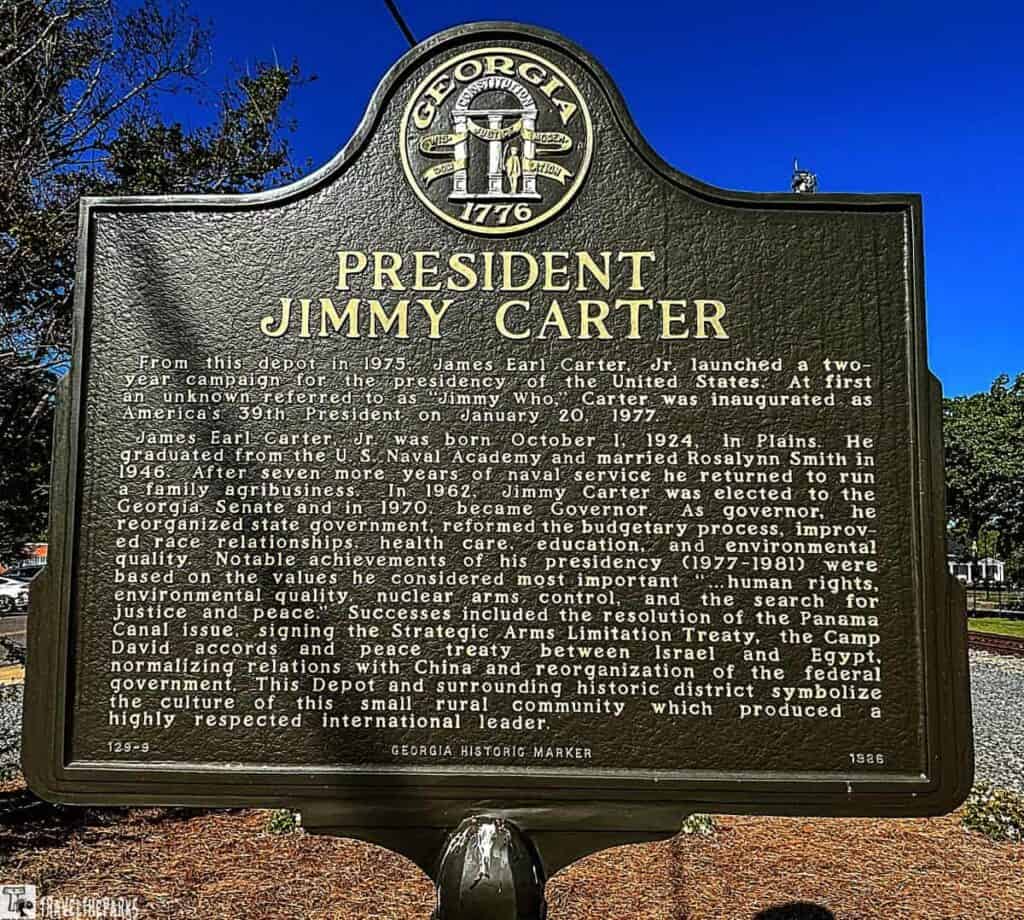 Historical marker for President Jimmy Carter with Georgia state emblem and text about his life and presidency.