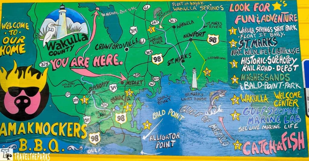 Colorful map of Wakulla County, Florida, showing attractions and roads with vivid illustrations and text.