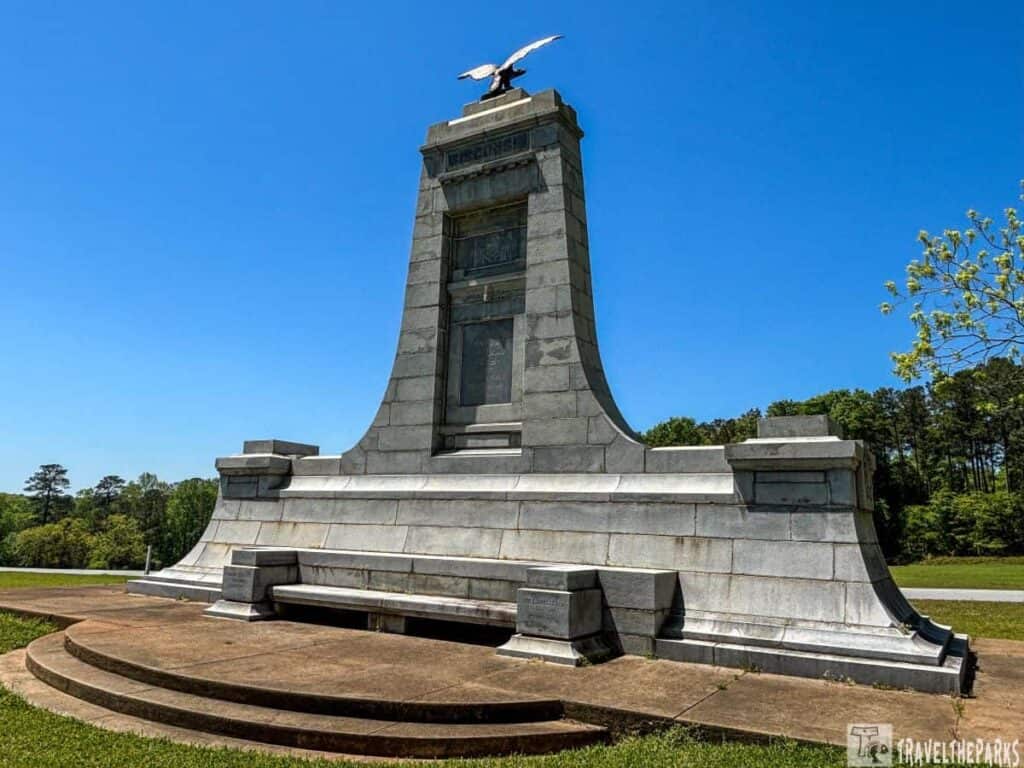 Stone Wisconsin monument with a tall pillar and an eagle statue at Andersonville National Historic Site.