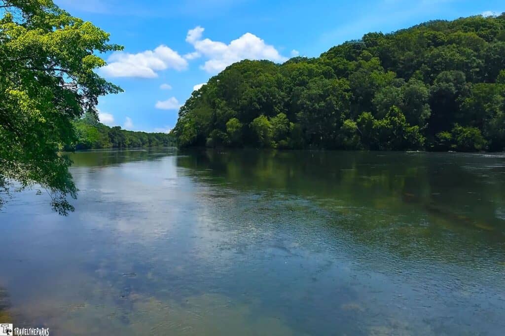 Chattahoochee River in Georgia with greenery and blue sky.