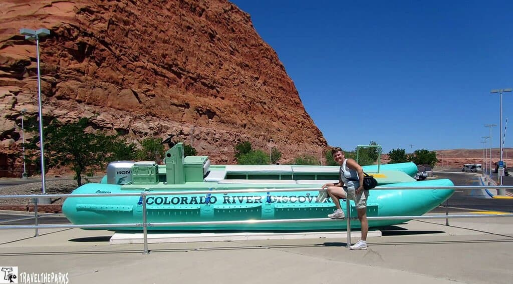 A turquoise-green submarine replica named "COLORADO RIVER DISCOVERY" with red rock formations in the background at the Glen Canyon National Recreation Area Visitor Center.