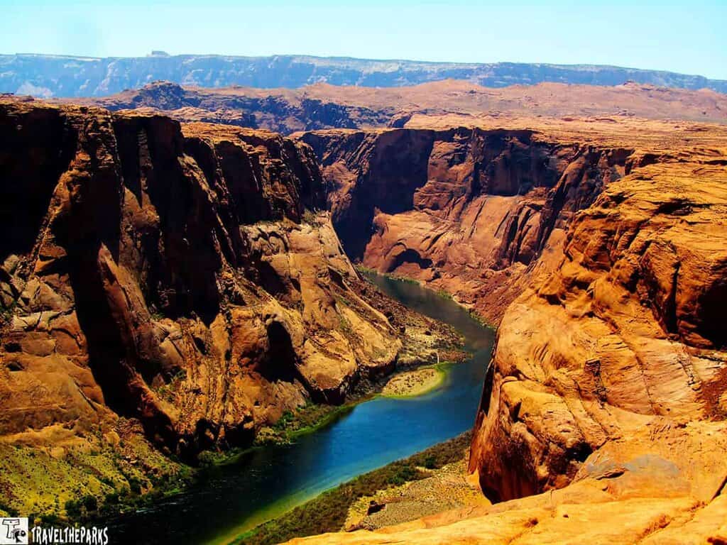 Aerial view of Horseshoe Bend in Glen Canyon, with the Colorado River curving around red canyon walls.
