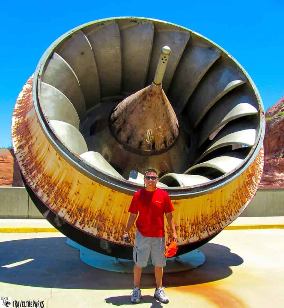 Man standing in front of large turbine at Glen Canyon Dam