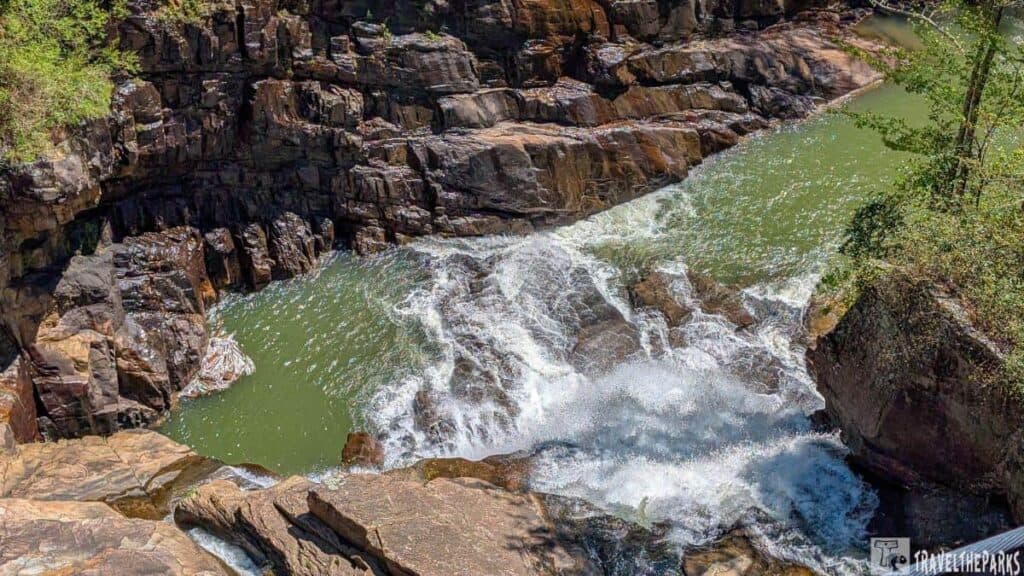 Top of Hrricane Waterfall at Tallulah Gorge State Park with rocky cliffs and greenish water.