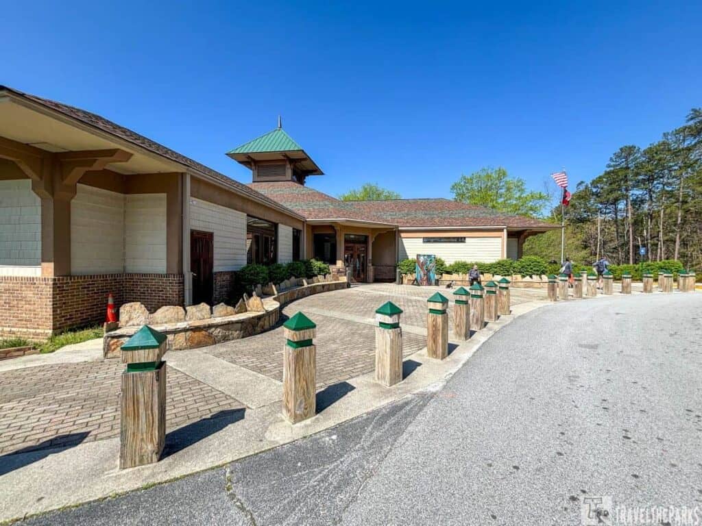 Exterior view of the Jane Hurt Yarn Interpretive Center with green roof and beige walls.
