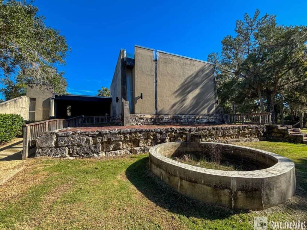 Fort San Marcos de Apalache Museum showing a modern structure with stone and concrete elements surrounded by trees.