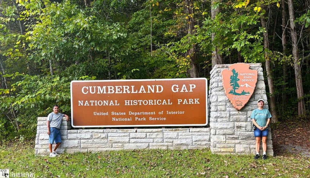 Sign for Cumberland Gap National Historical Park with two people standing on either side.