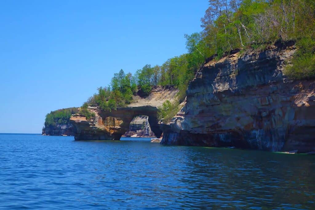 Lover's Leap-Rock cliffs with a natural arch over blue water at Pictured Rocks National Lakeshore.