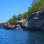 Lover's Leap-Rock cliffs with a natural arch over blue water at Pictured Rocks National Lakeshore.