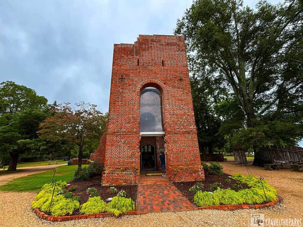 The facade of a red brick church tower, part of the 17th century structure abutting the 1907 Memorial Church at Historic Jamestowne.