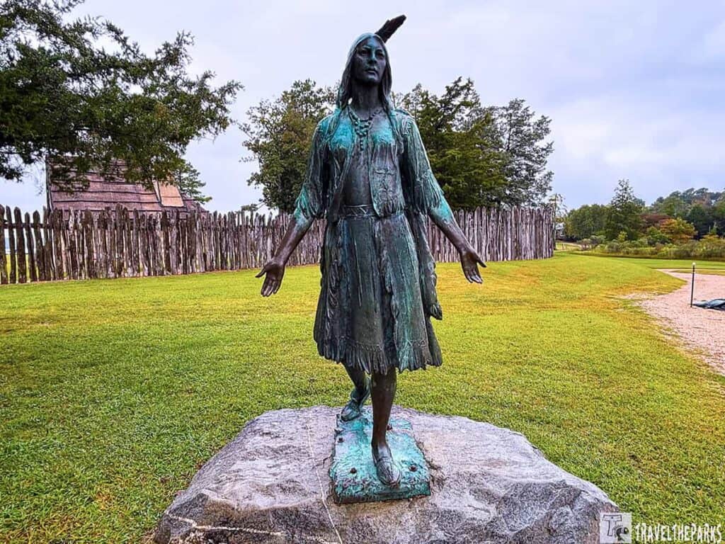 Statue of Pocahontas by William Partridge in Historic Jamestowne, set on a grassy landscape.